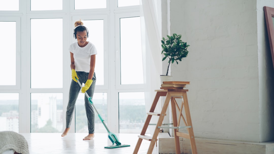 Woman mopping floor while listening to music embracing daily movement
